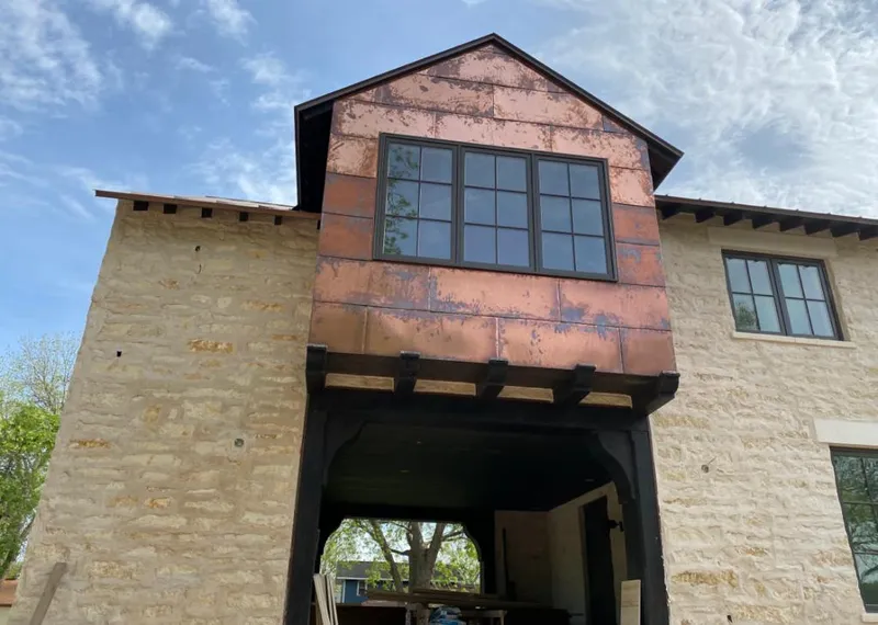 Copper metal panel facade on a stone building for Roof Repair in Yakima